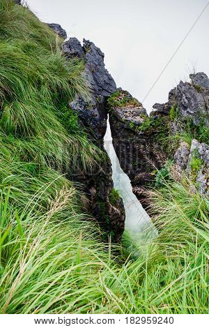 The hole between mountain with green grass