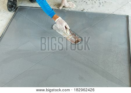 worker are plastering mixed cement terrazzo on the mold