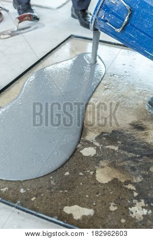 Mixed mortar leveling into a mold by worker