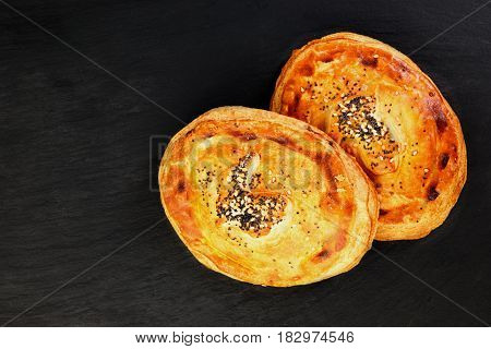 Freshly salmon pie on black slate plate