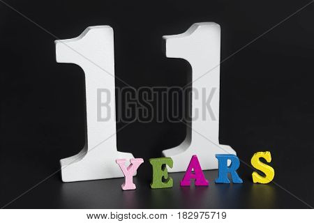 Letters and numbers eleven years on black isolated background.