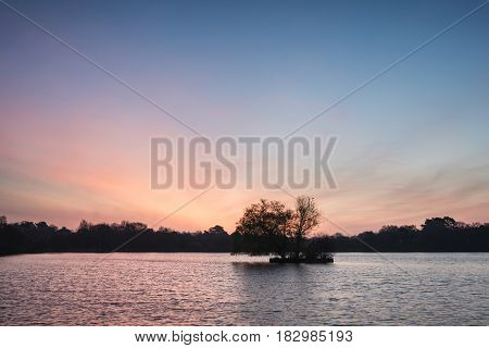 Beautiful Vibrant Spring Sunrise Over Calm Lake In English Countryside