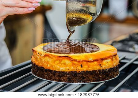 Hands putting custard on shortcake. Man prepares dessert at table. Sweet and dense filling.