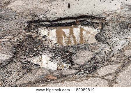 Large unfixed pothole on Montreal street in springtime