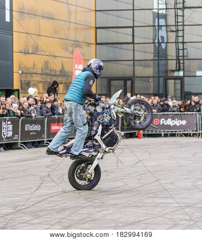 St. Petersburg Russia - 15 April, Doing the tricks on a motorcycle,15 April, 2017.
International Motor Show IMIS-2017 in Expoforurum.
Sports motorcycle show of bikers on the open area.