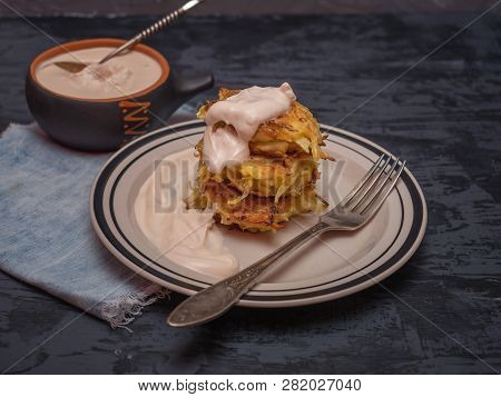 Cabbage Oladi With Sour Cream, A Cup With Stewed Sour Cream On A Dark Wooden Table, Denim Napkin, Cu