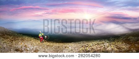 Cyclist In The Autumn Mountains