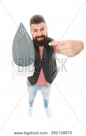 Household Ironing. Bearded Man Pointing At Clothes Iron. Hipster Presenting Electric Ironing Tool. U