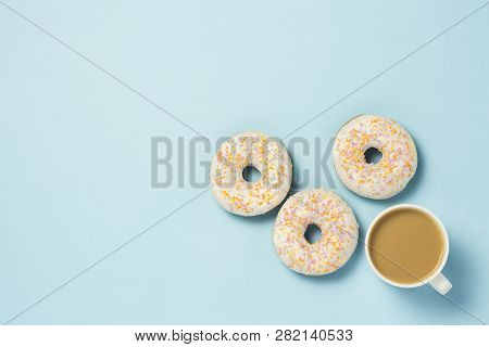 White Cup, Coffee Or Tea With Milk And Fresh Tasty Donuts On A Blue Background. Bakery Concept, Fres