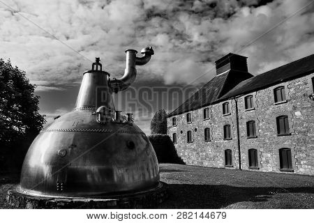 Cork, Ireland - June 20, 2008:  Old Big Copper Whiskey Distillery On Stone Foundation At The Jameson