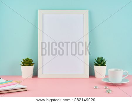 Mockup With Blank White Frame, Plant Cactus, Cup Of Coffee Or Tea On Pink Table Against Blue Wall Wi