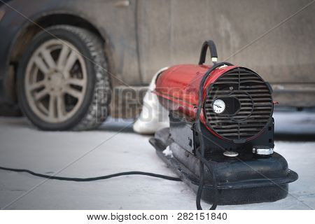 Emergency Car Engine Warming In Winter With A Heater. Flooded Spark Plugs Of Car And Failure To Star