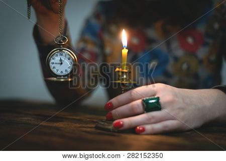 Brass Pocket Watch With Arrows On A Almost Twelve O Clock  In A Hand Of A Woman. Time To Tell A Secr