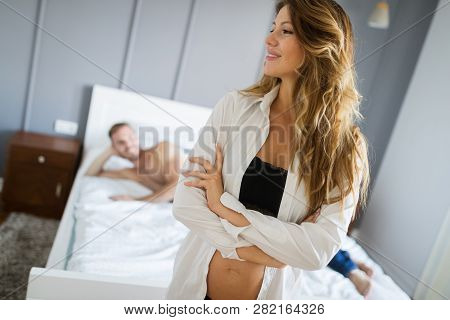 Attractive Sexy Woman With Her Partner In Bedroom