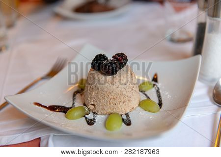 Almond Ice Cream Cone On Plate Witch Chocolate With Blackberries And White Grapes