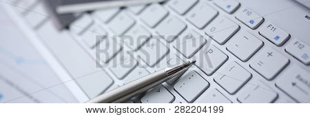 Silver Pen With Credit Card Lie White Keyboard Pc Buttons Closeup. Financial Transfer Security When 