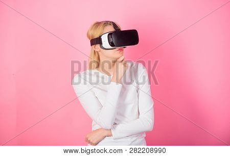 Young Woman Using A Virtual Reality Headset. Happy Woman Exploring Augmented World, Interacting With