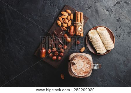 Chocolate Smoothie In A Jar, Protein Milkshake, Nuts, Chocolate Cubes, Banana Slices, Dates, Cinnamo
