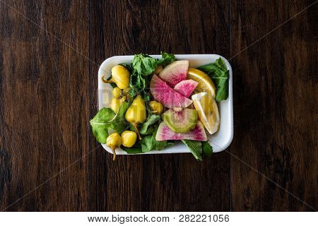 Package Of Salad With Turkish Pickle, Radish, Parsley And Lemon In Plastic Box Container.