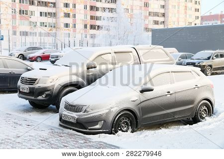Novyy Urengoy, Russia - January 26, 2019: Motor Car Kia Rio Covered With Snow In The City Street.