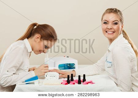 Relaxing Time And Wellness Day Concept. Blonde Elegant Woman Visiting Professional Manicurist Salon.