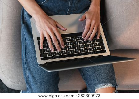Cropped View Of Young Woman Hands On Laptop Keyboard