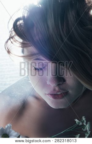 Close Up Of Beautiful Girl Posing Underwater With Flowers