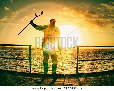 Morning Passanger On Ferry Pier In Dock Wait For Firts Ferry Boat. Sunrise Above Horizon.