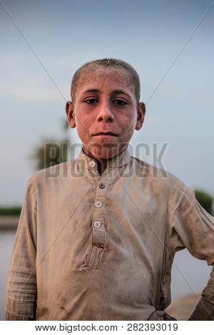 Portrait Of A Village Boy, Standing And Looking At Camera In Sindh, Moro, Pakistan 26/08/2017