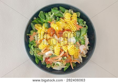 Salad made from radiatori cooked pasta, goat cheese and oil vinaigrette
