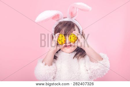Portrait Of A Little Girl With Bunny Ears And Easter Eggs