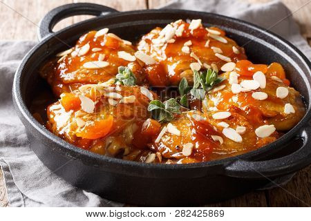 Baked Chicken Thighs With Apricot Glaze And Almond Flakes Close-up On The Table. Horizontal