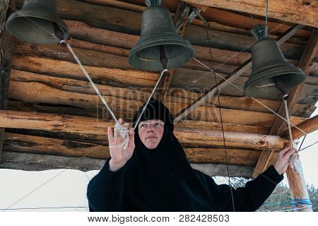 Starosillia, Volyn / Ukraine - February 04 2009: Woman Bell-ringer In Orthodox Church Bell Tower