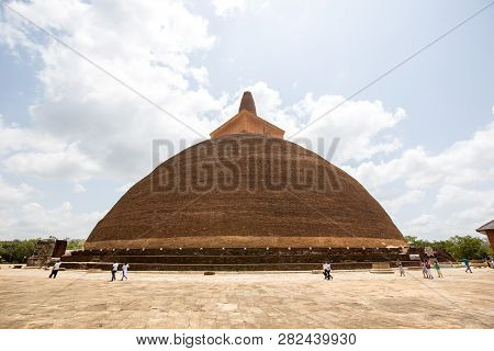 Anuradhapura, Sri Lanka - August 21, 2018: Devotees Walking Around The Ancient Buddhist Stupa Abhaya
