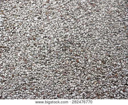 Background Of The Wall Of The Building Lined With Decorative Stone Powder Under Gray Granite