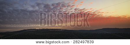 The Setting Sun Paints The Clouds Red Above The Mountains Near Jerusalem, Israel