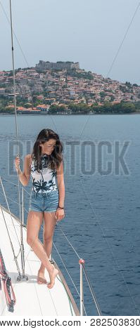 Young Teen Girl Inshorts Standing On Deck Of Sailboat