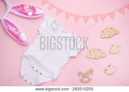 Mockup Layout Flat Lay A White Baby Bodysuit On A Pink Background, For Girls With Gifts. Layout For