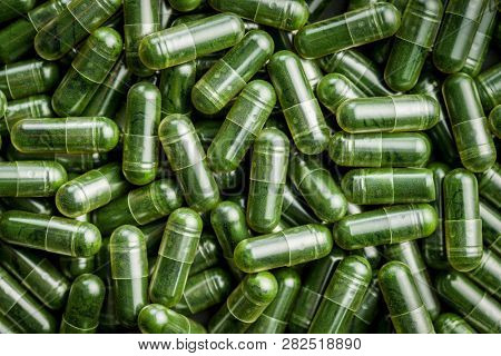 Green chlorella pills or green barley pills. Texture.