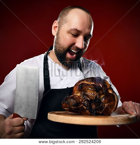 Inspired Professional Chef Going To Slice Steaming Meat Laying On A Wooden Cutting Board With A Big 