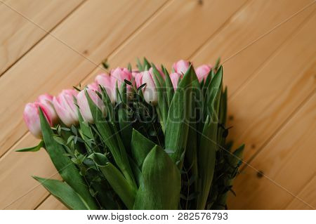 Bright Pink Flowers On Wooden Background. Colorful Bouquet For Valentines Day