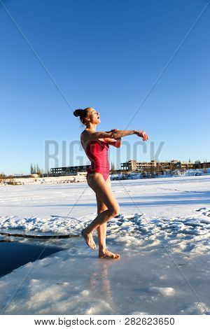 Young Woman Crosses Herself Plunging Into Icy Water During Ukraine
