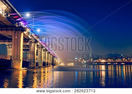 SEOUL, SOUTH KOREA - APRIL 7, 2017: Banpo Bridge Rainbow Fountain tourist landmark on Han river illuminated at night, Seoul, South Korea
