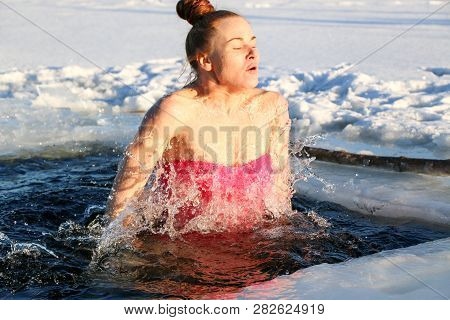 Young Woman Crosses Herself Plunging Into Icy Water During Ukraine