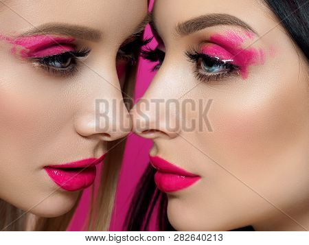 Closeup Portrait Of Two Young Beautiful Women With Fashion Pink Makeup. Bright Pink Lip Gloss And Ey