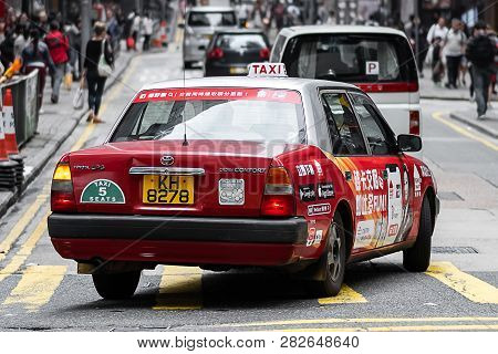 Red And White Colors Taxi Cab, Symbol Of Hk, Near Lan Kwai Fong Square Of Streets In Central Distric