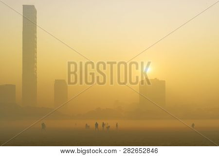 Beautiful Image Of Sunrise At Kolkata Maidan In A Foggy Winter Morning. Sunrises At The Horizon Abov