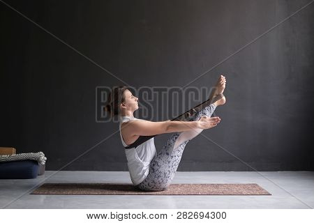 Woman Practicing Yoga, Doing Paripurna Navasana Exercise, Balance Pose