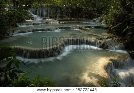 The Tiered Platforms Of Cool Turquoise Waters At The Foot Of The Kuang Si Waterfall,near Luang Praba