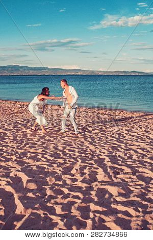 Leisure. Couple In Love Hanve Leaisure Time On Beach
